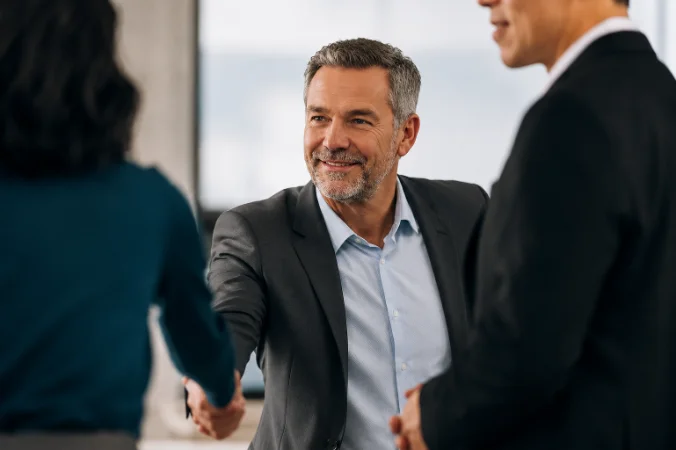 Two people shaking hands in an office